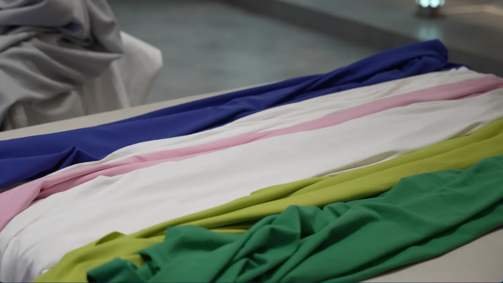 Cofinay activewear fabric samples in multiple colors arranged for material comparison.